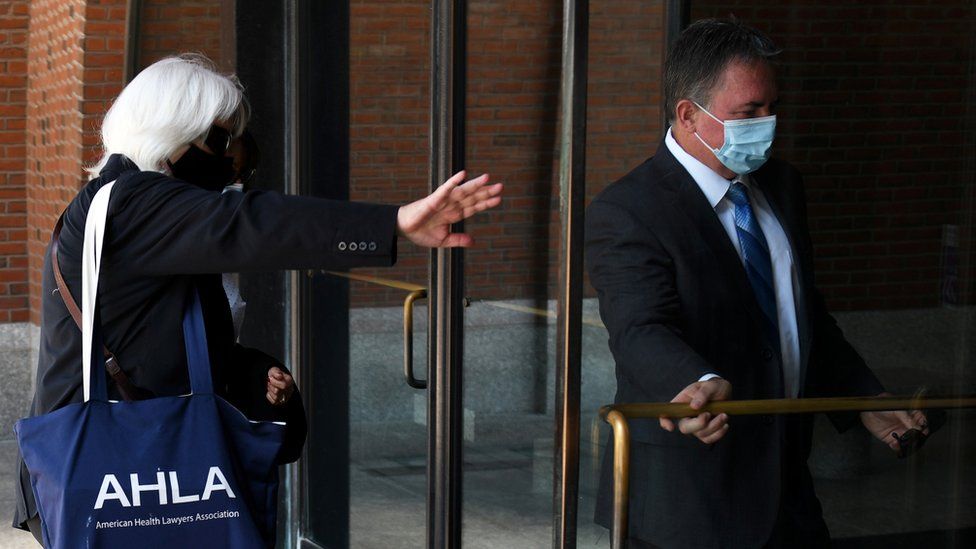 Philip Cooke (right) arrives for sentencing at a Boston court