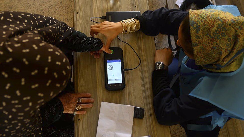 A fingerprint is read at a polling station in 2019