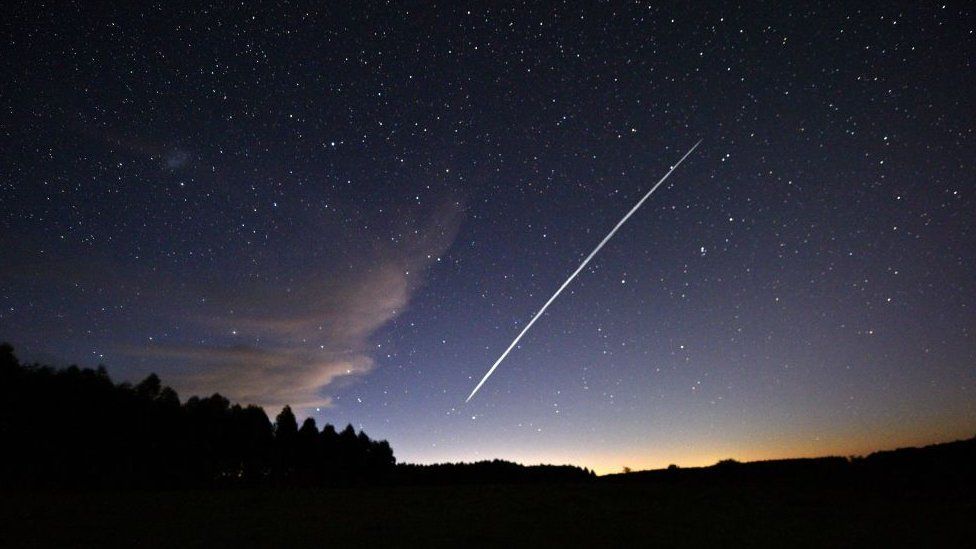 A long-exposure image of a group of SpaceX's Starlink satellites