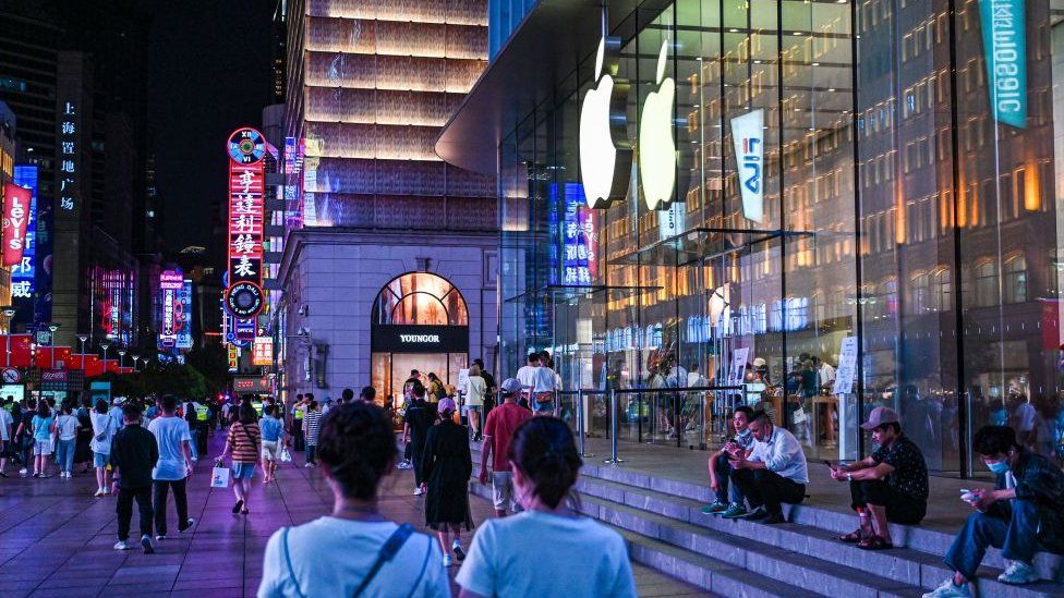 Image caption, Apple's flagship stores in China, like this one in Shanghai, match those in other major cities worldwide