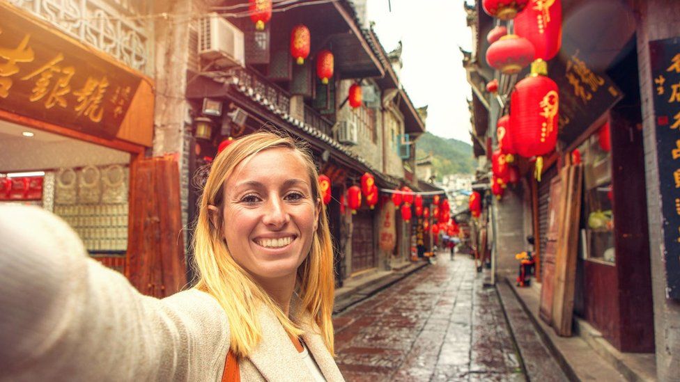 Airbnb. Woman taking a selfie in China