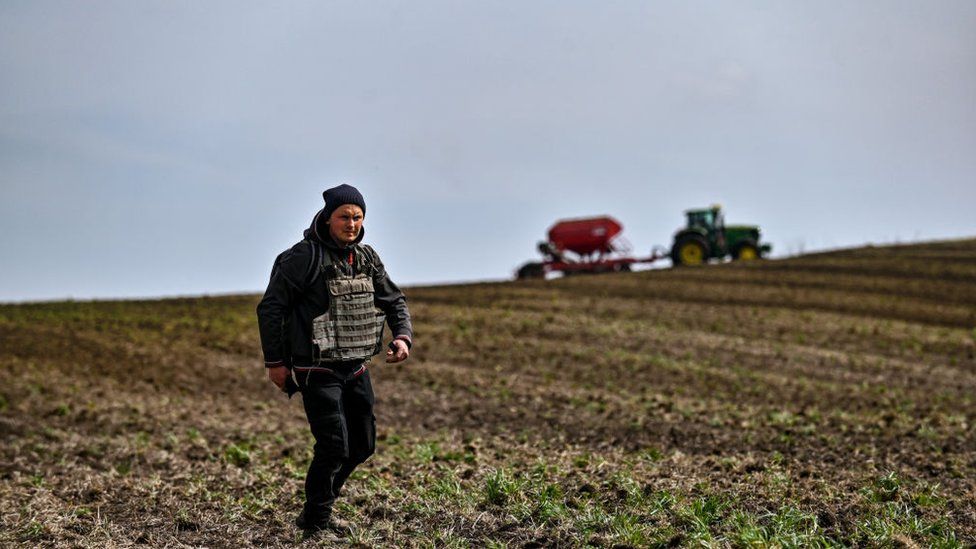 , A farmer wears a flak jacket during spring sowing in the Zaporizhzhia region