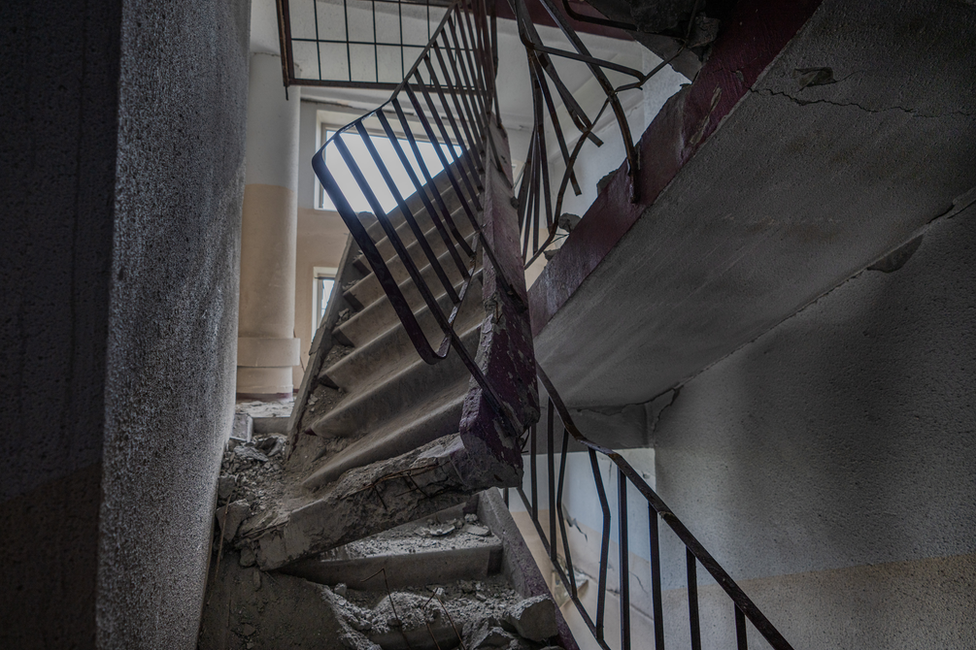 , The concrete stairwell two floors above Roman's apartment, smashed by a direct hit on the roof
