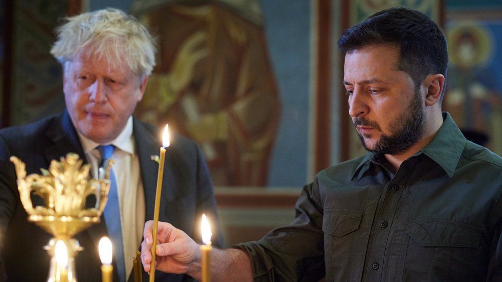 Handout photo issued by the Ukrainian Presidential Press Office of Prime Minister Boris Johnson (left) and Ukrainian President Volodymyr Zelensky (right), lighting candles at the Mikhailovsky Zlatoverkhy Cathedral (St. Michael"s Golden-Domed Cathedral) in Kyiv, Ukraine,