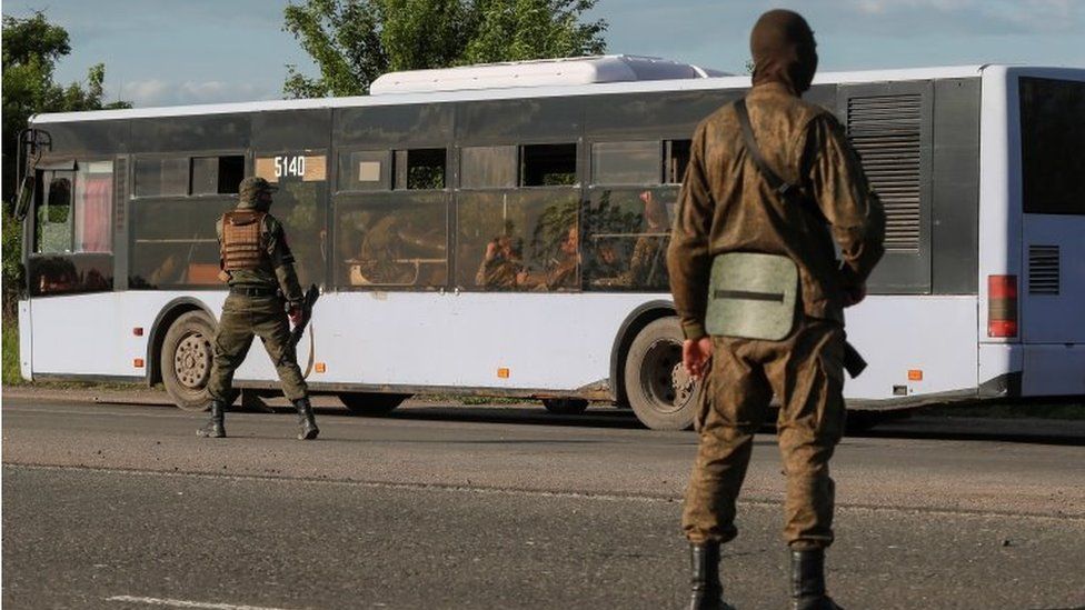 Captured Ukrainian troops on a bus - both sides claim to have taken thousands of prisoners