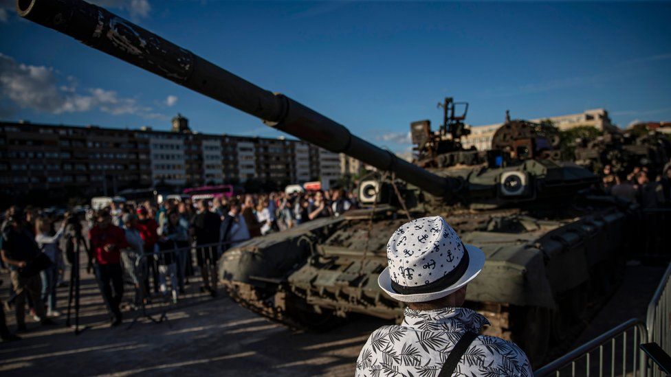 People look at a Russian tank on display in Prague