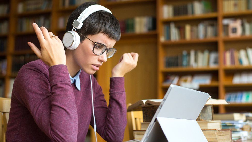 Heardle. stock image of an annoyed woman wearing headphones