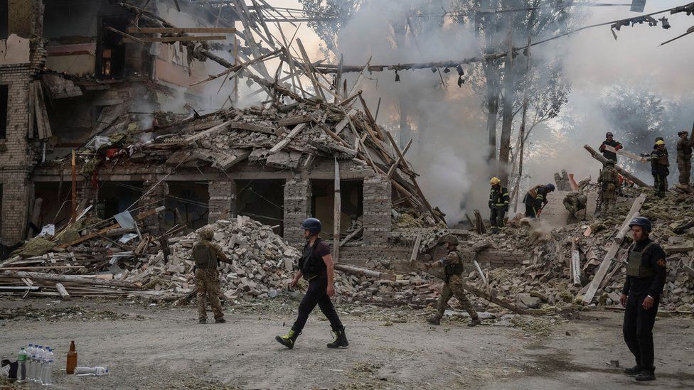 Rescuers work at a school building damaged by a strike in Kramatorsk, in the Donetsk region of Ukraine
