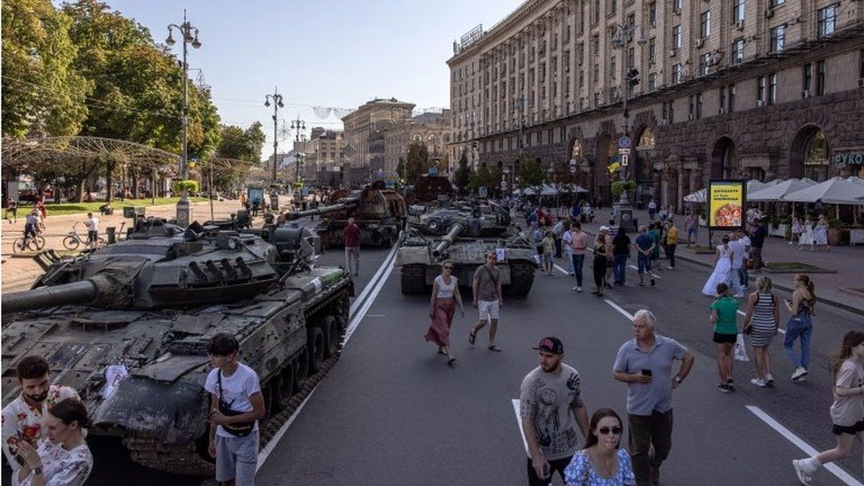 In Kyiv, people walked past Russian armoured military vehicles that were captured in fighting