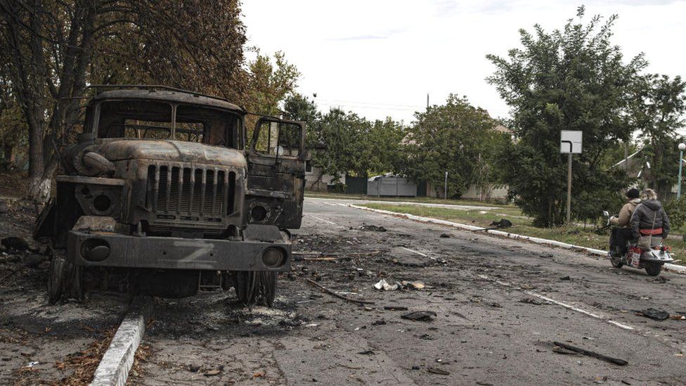 Destroyed military vehicles abandoned by Russian forces line the roads of Balakliya