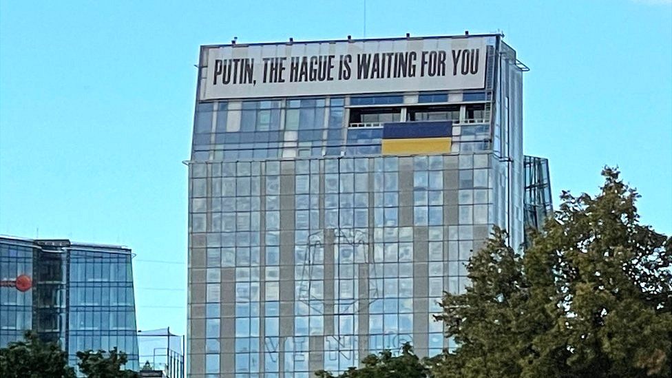 A building in central Vilnius, Lithuania, displays an anti-Putin message above the Ukrainian flag