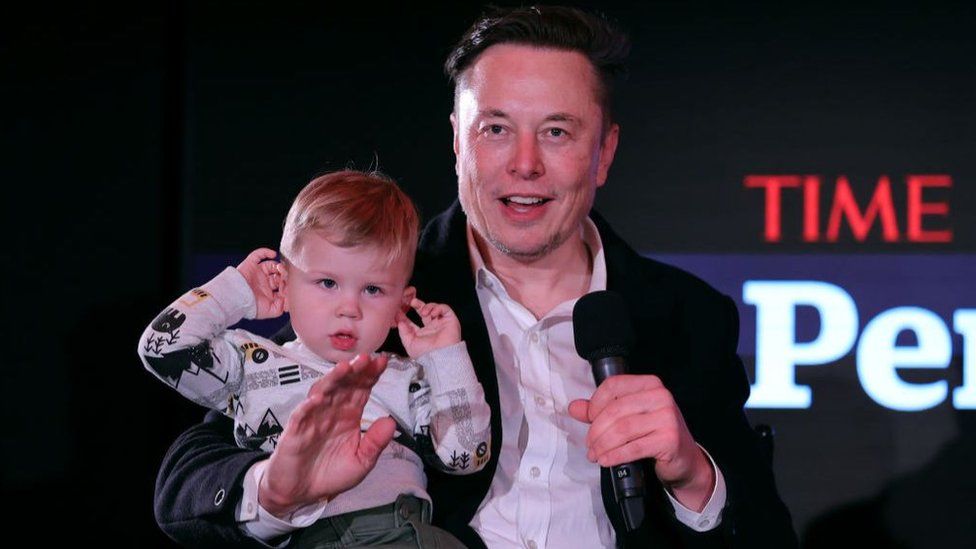 Elon Musk and his son X Æ A-12 in 2021. Mr Musk, a father of nine, has called "population collapse" a bigger risk than global warming
