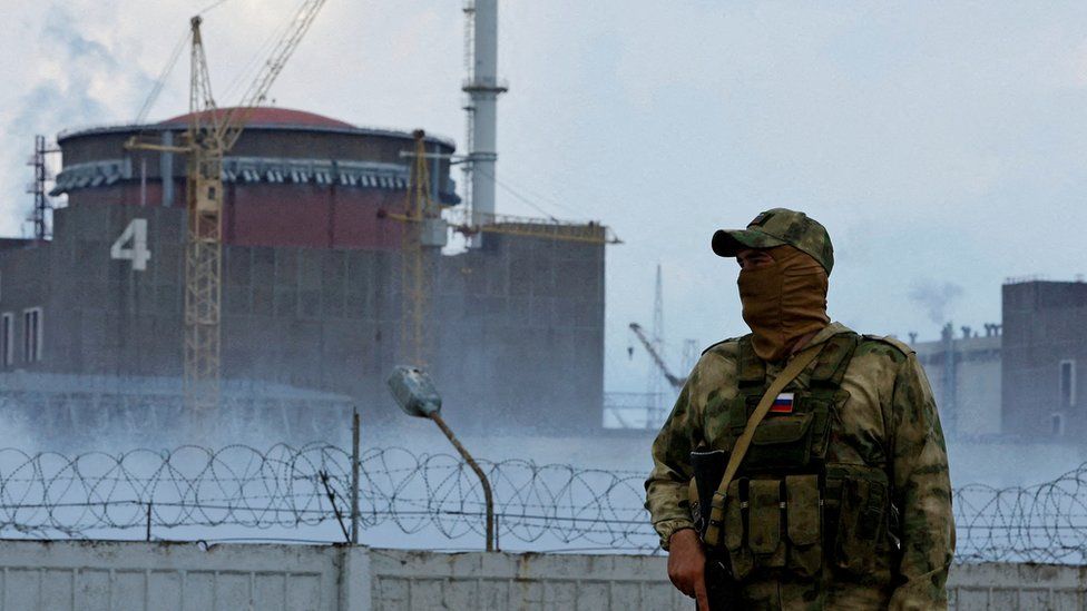 A Russian soldier stands guard near the Zaporizhzhia nuclear power plant