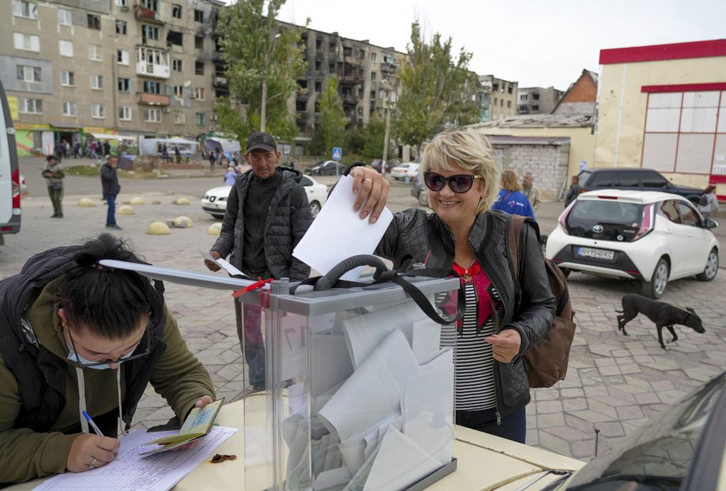 A woman casts her vote in Russia's so-called referendum in Mariupol, Donetsk, 26 September 2022