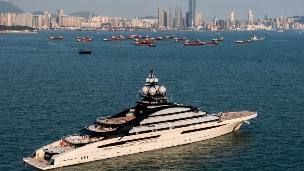 The Nord superyacht docked in Hong Kong waters with the city skyline in the background