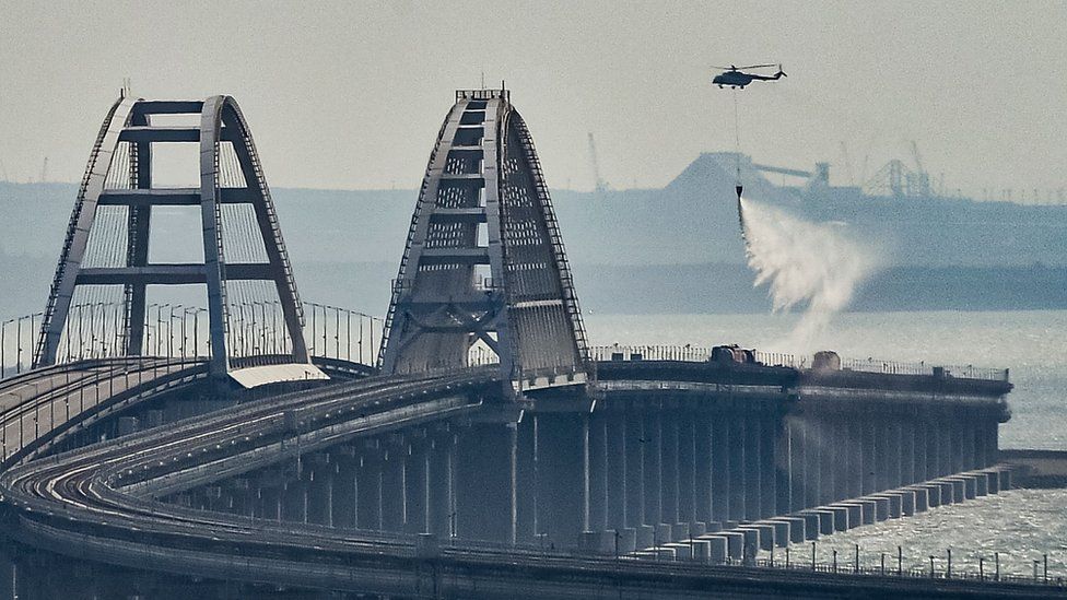 A firefighter helicopter pours water on fire on a collapsed part of the Kerch Strait bridge in Crimea last Saturday