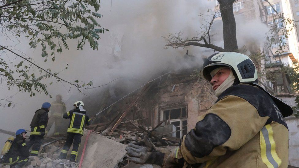 Ukrainian firefighters at the site of a drone attack in Kyiv on Monday