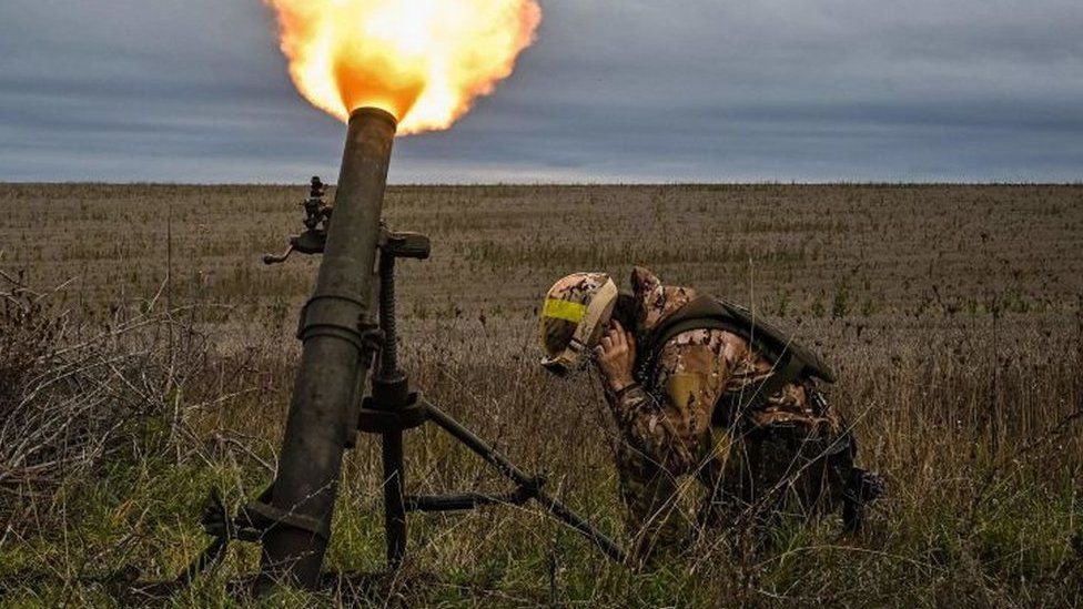 A Ukrainian soldier fires a mortar