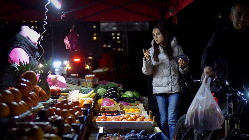 Kyiv's residents are having to improvise during frequent blackouts - like at this street market