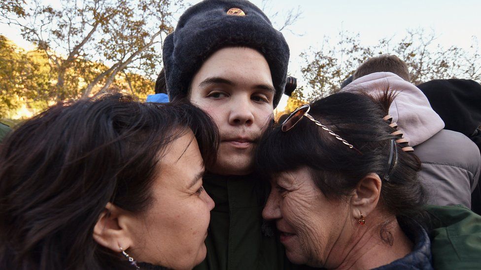 A conscript in Russian-annexed Crimea bids farewell to his relatives before leaving to serve in the Russian army