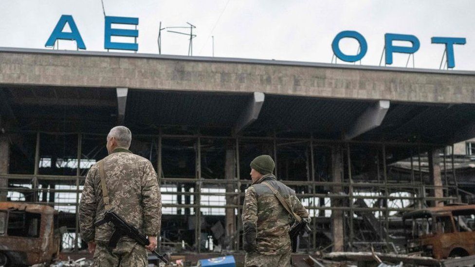 Ukrainian soldiers survey the destroyed airport building days after recapturing Chornobaivka