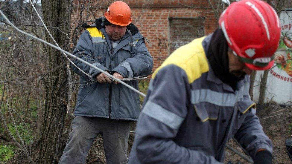 Workers in the Donetsk region repair broken power lines on Friday