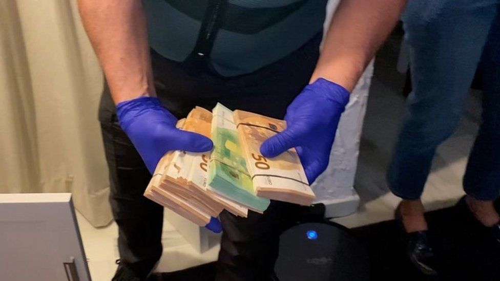 Large amounts of cash were seized during the raids