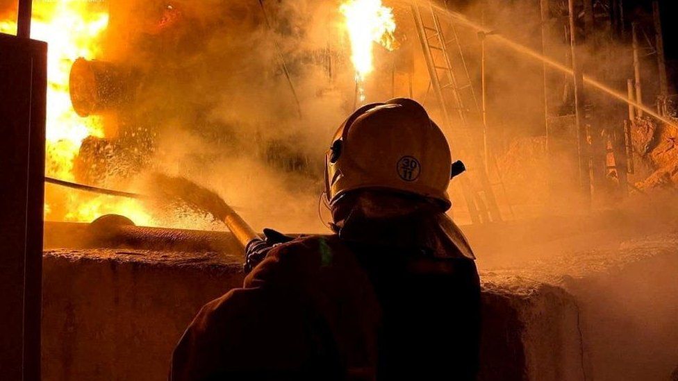 A firefighter works to extinguish a fire at a power infrastructure object in Odesa on 6 December