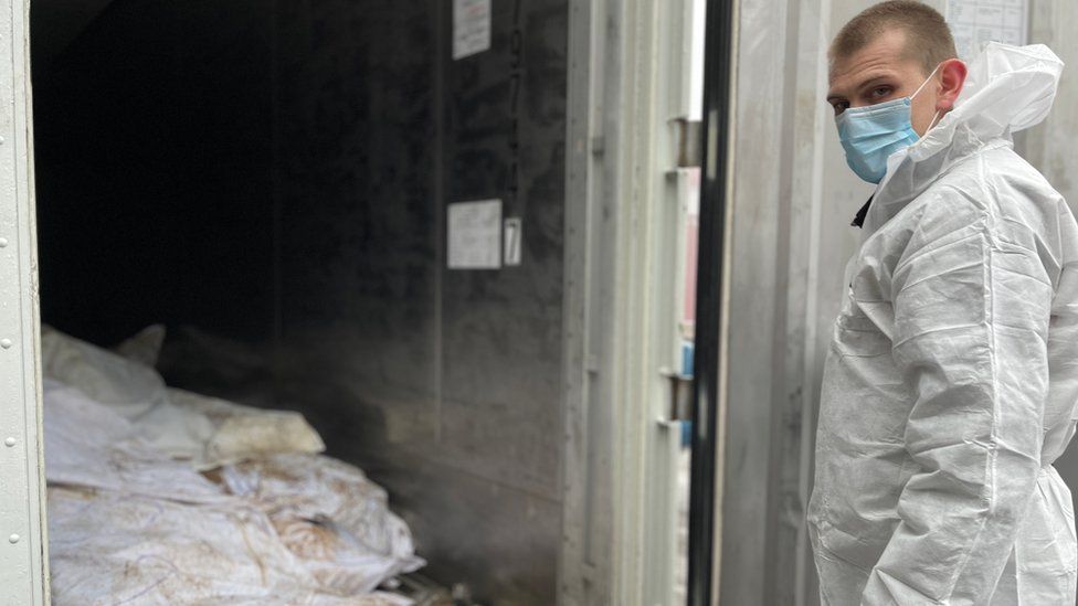The unidentified remains of some of those killed in Izyum are being kept in a container in Kharkiv