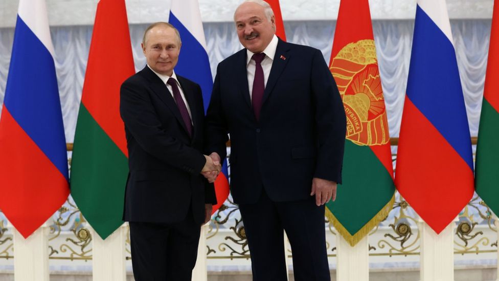 Vladimir Putin and Alexander Lukashenko shake hands before their meeting at the Palace of Independence in Minsk