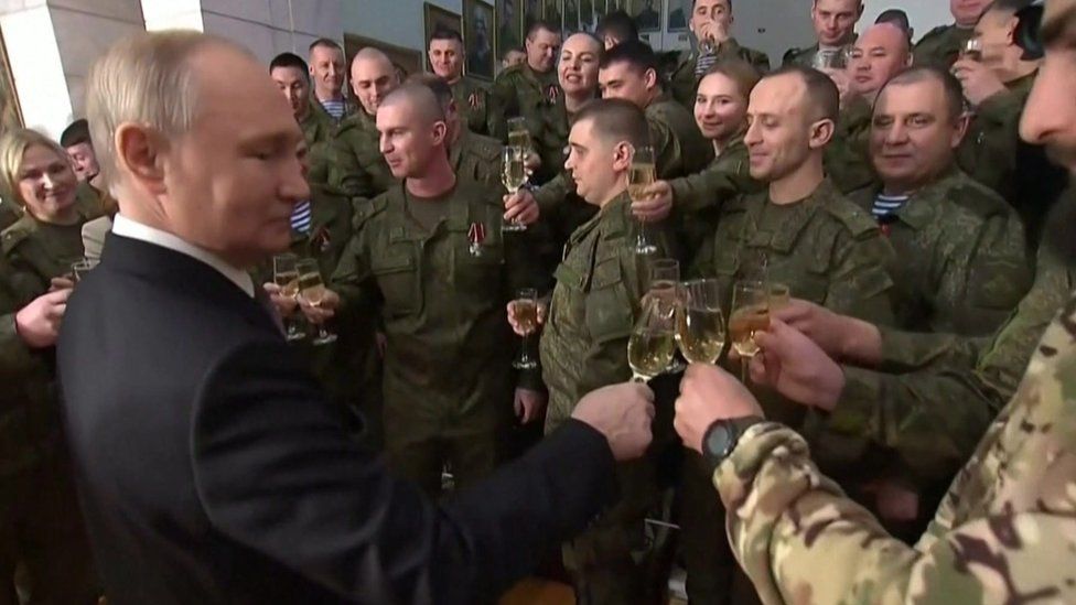 President Putin was pictured celebrating with members of the military, who he presented with medals