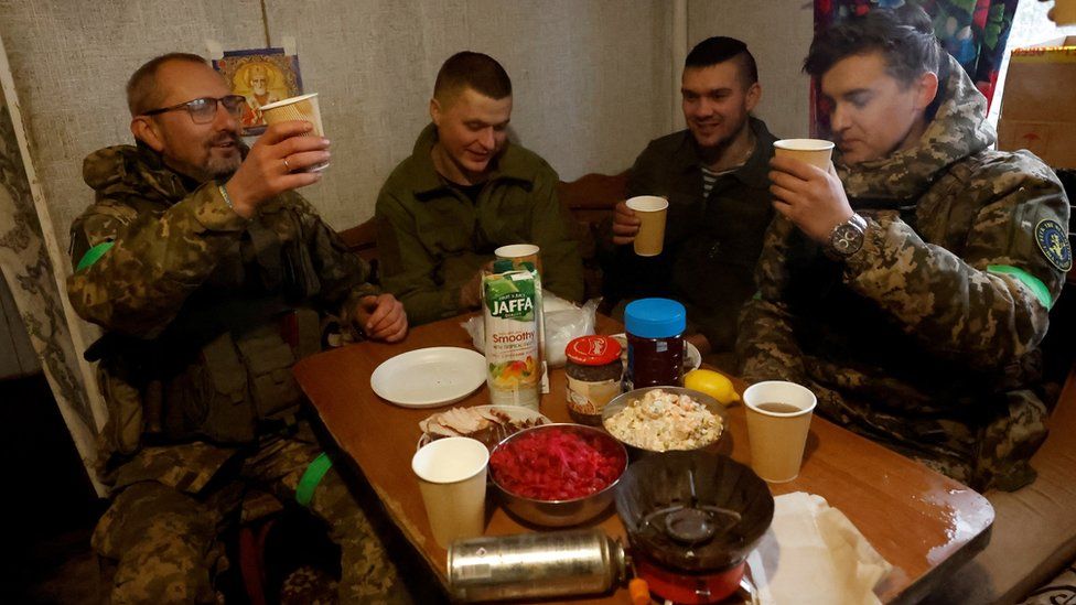 Across Ukraine, celebrations were coloured by the ongoing war. Ukrainian troops fighting near the front line in the Donbas region toasted each other during a brief moment of respite.
