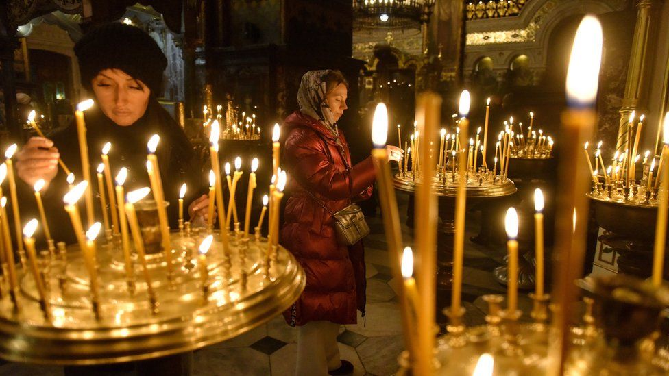 In Kyiv, believers lit candles at St Volodymyr's Cathedral. Millions of other Ukrainians flocked to churches across the country at the end of a brutal year of war.