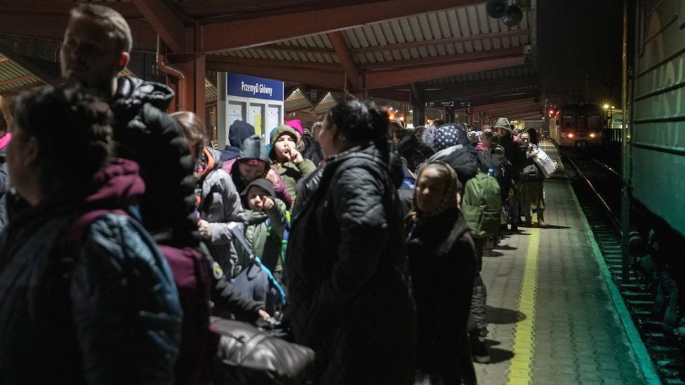 People queue on the platform at Przemysl station with free tickets for an evacuation train to Hanover, Germany