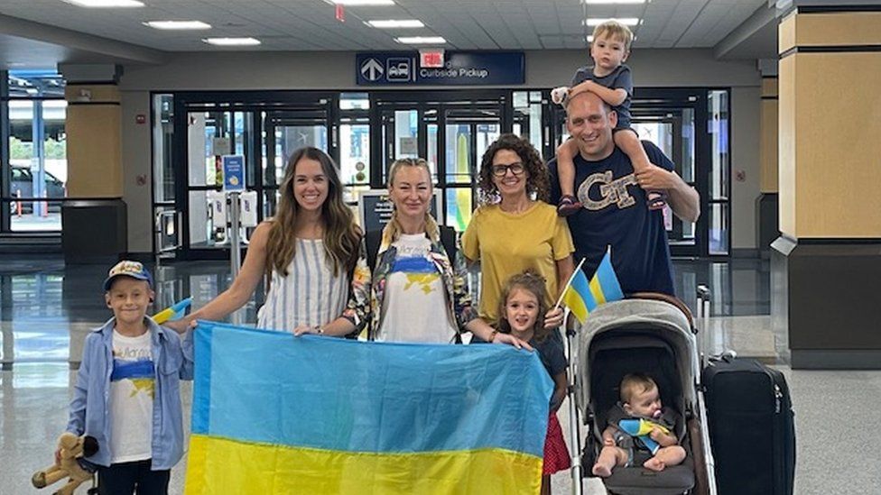 Kelly Wheeler with Viktoriia Kuznietsova and their families