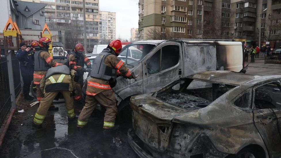 Emergency workers attended burning cars damaged by the Russian missile strikes in Kyiv