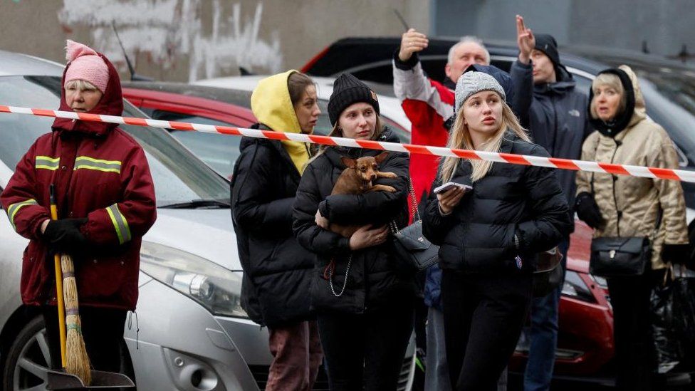 People gathered outside a residential building in Kyiv following the strikes
