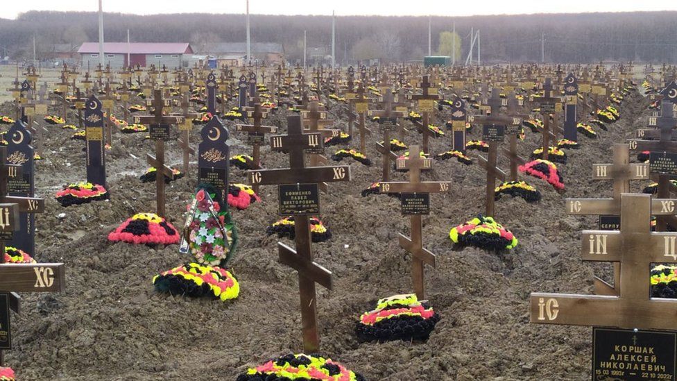 The small village cemetery has sprawled outward as the death toll has mounted
