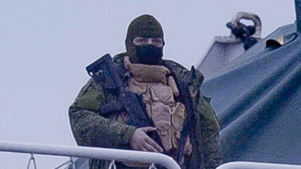 An armed man confronted the reporter when he approached the ship
