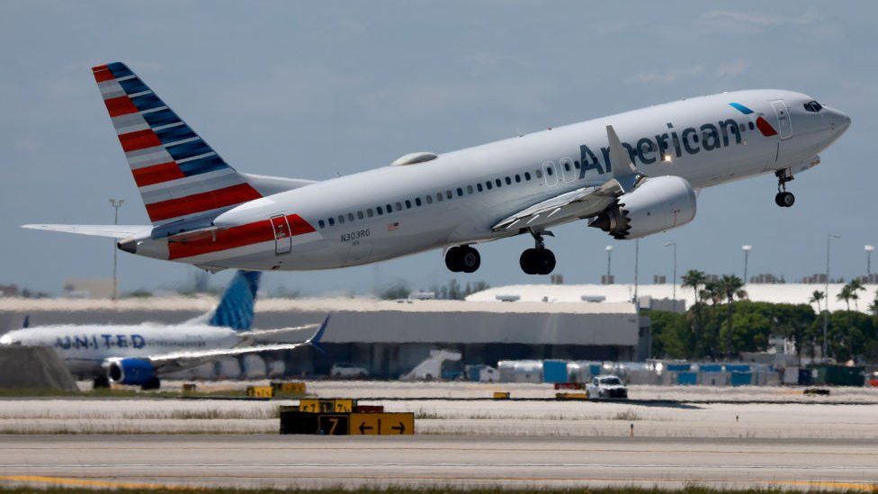 An American Airlines plane leaves a runway