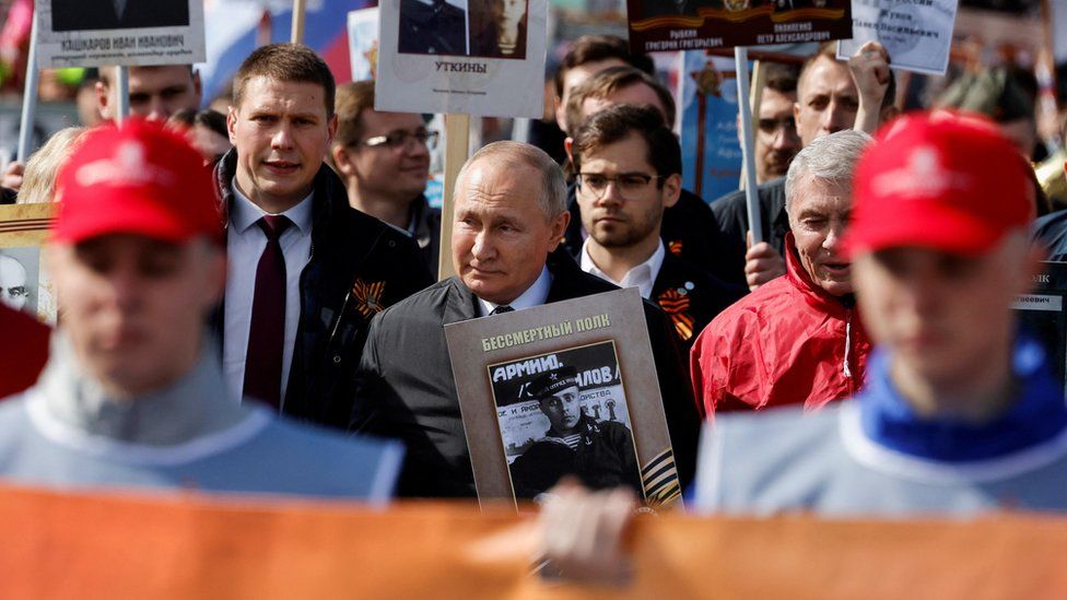 President Putin carrying a photograph of his father during last year's Victory Day celebrations