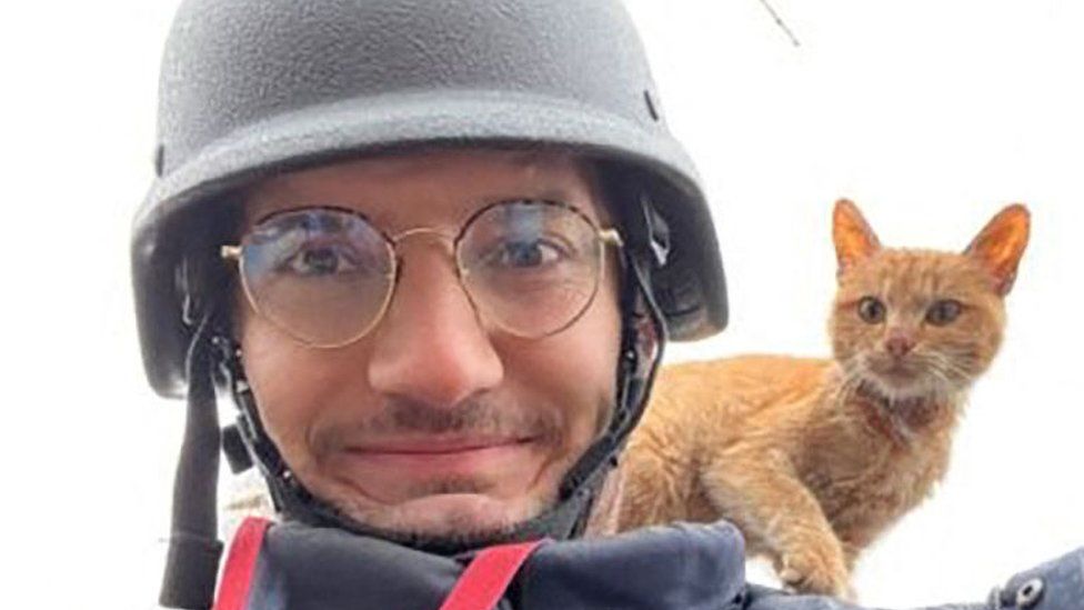 A French journalist who was killed smiles with a cat on his shoulder
