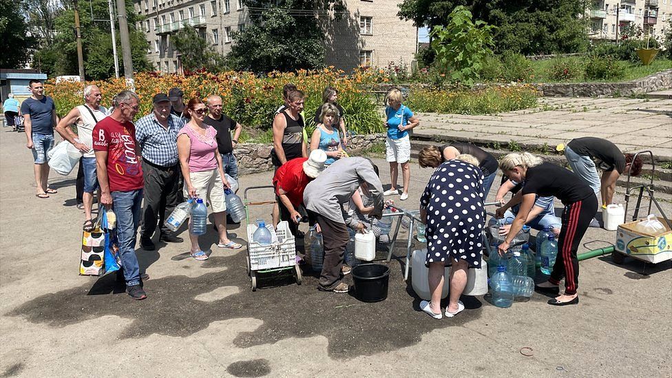 People queue to access drinking water in Marhanets, a Ukrainian town often targeted by Russian strikes