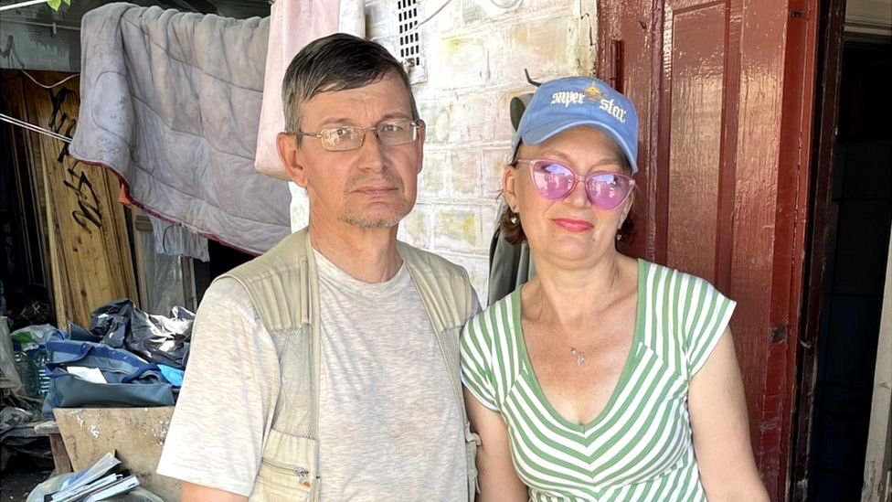 Irina (R), with her husband Evhenii, said the water reached the roof of their small cottage close to the Dnipro River