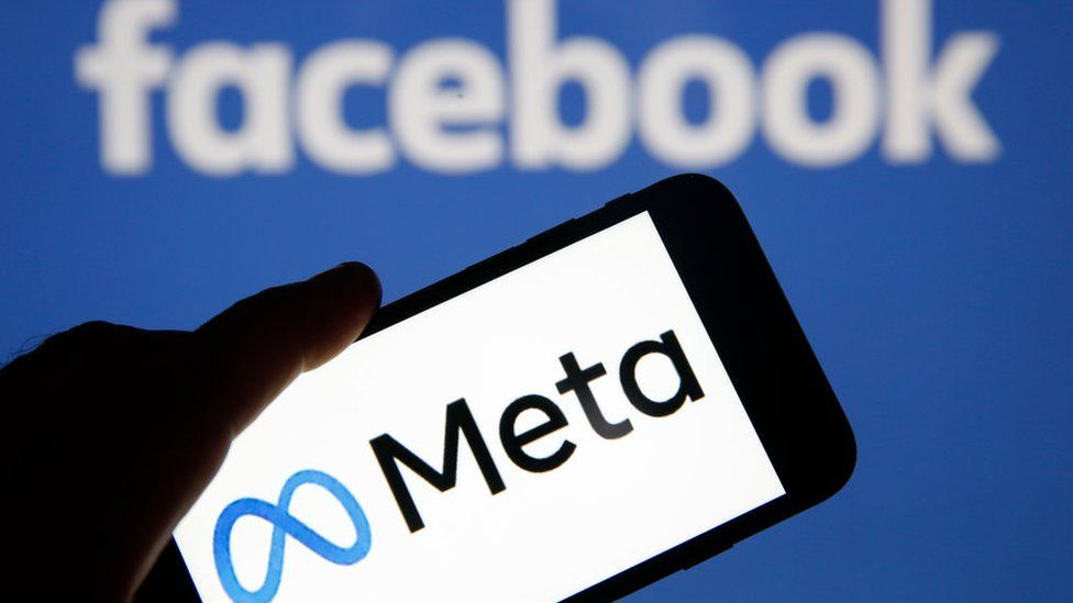 In this photo illustration, the Meta logo is displayed on the screen of an iPhone in front of a Facebook logo on October 29, 2021