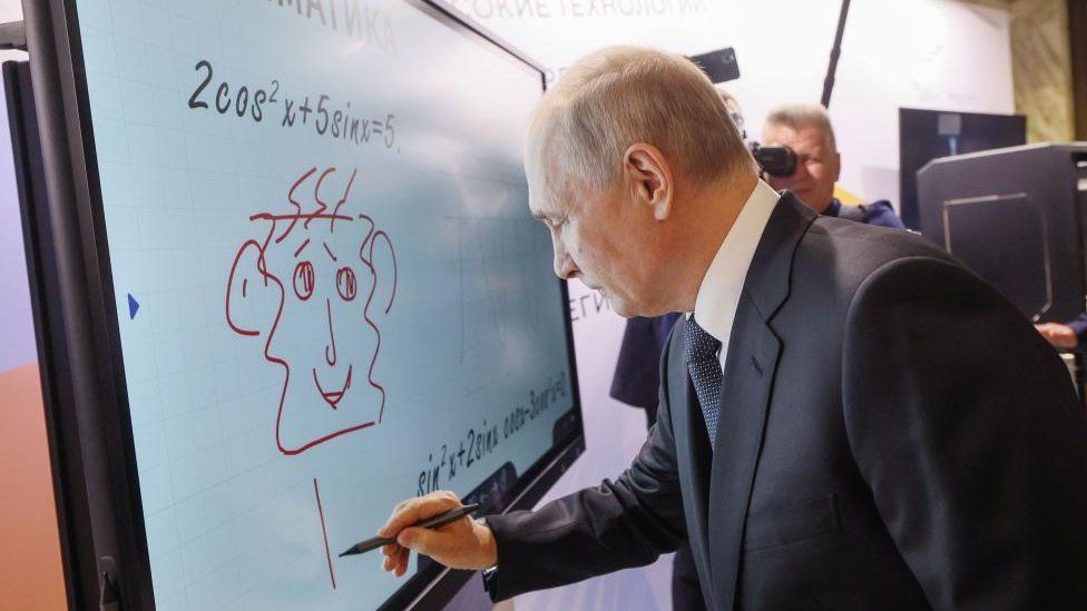 Russian President Vladimir Putin doodles on a white board