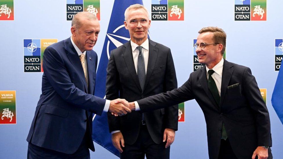 Turkish President Recep Tayyip Erdogan and Swedish Prime Minister Ulf Kristersson shake hands with Nato chief Jens Stoltenberg looking on