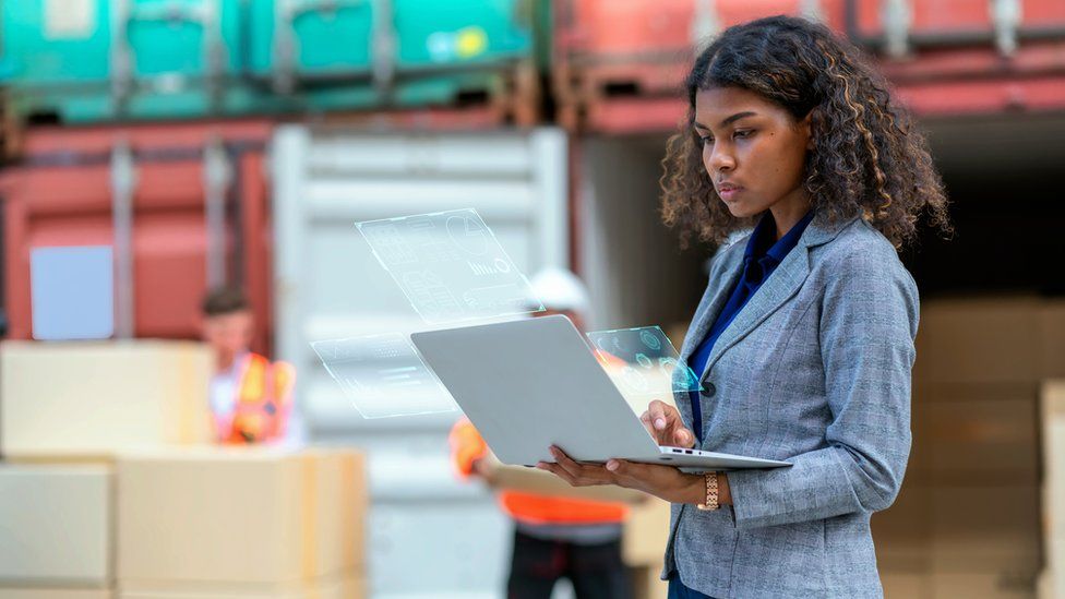 A woman using a laptop in a port