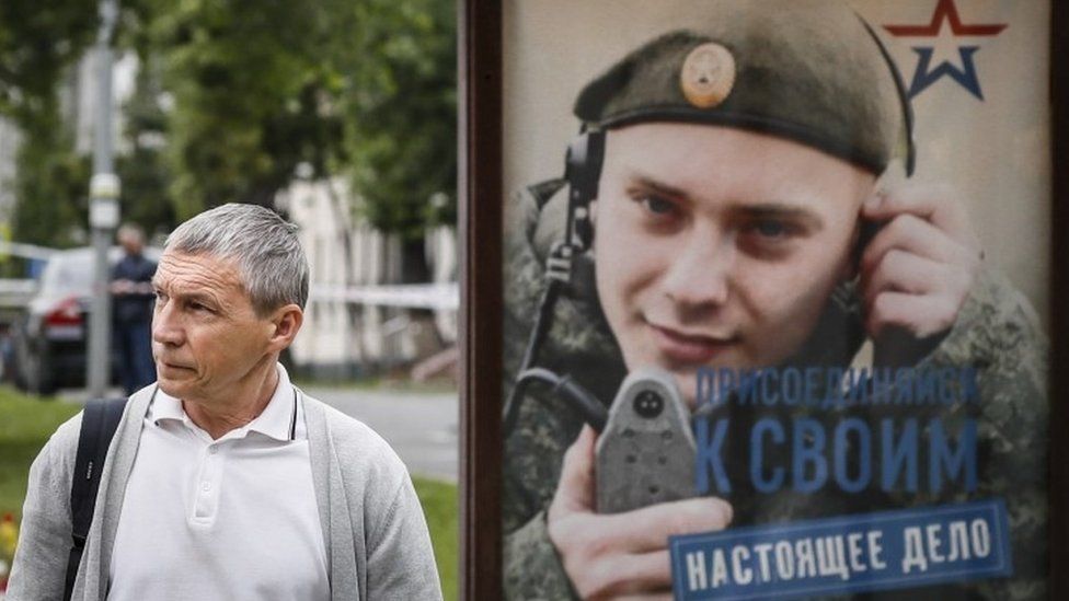 A poster on a bus shelter in Moscow encourages young men to join up for a "real cause"