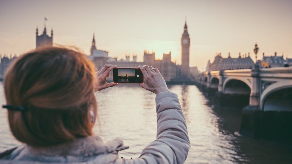 Stock photo of picture of Parliament being taken on a smartphone